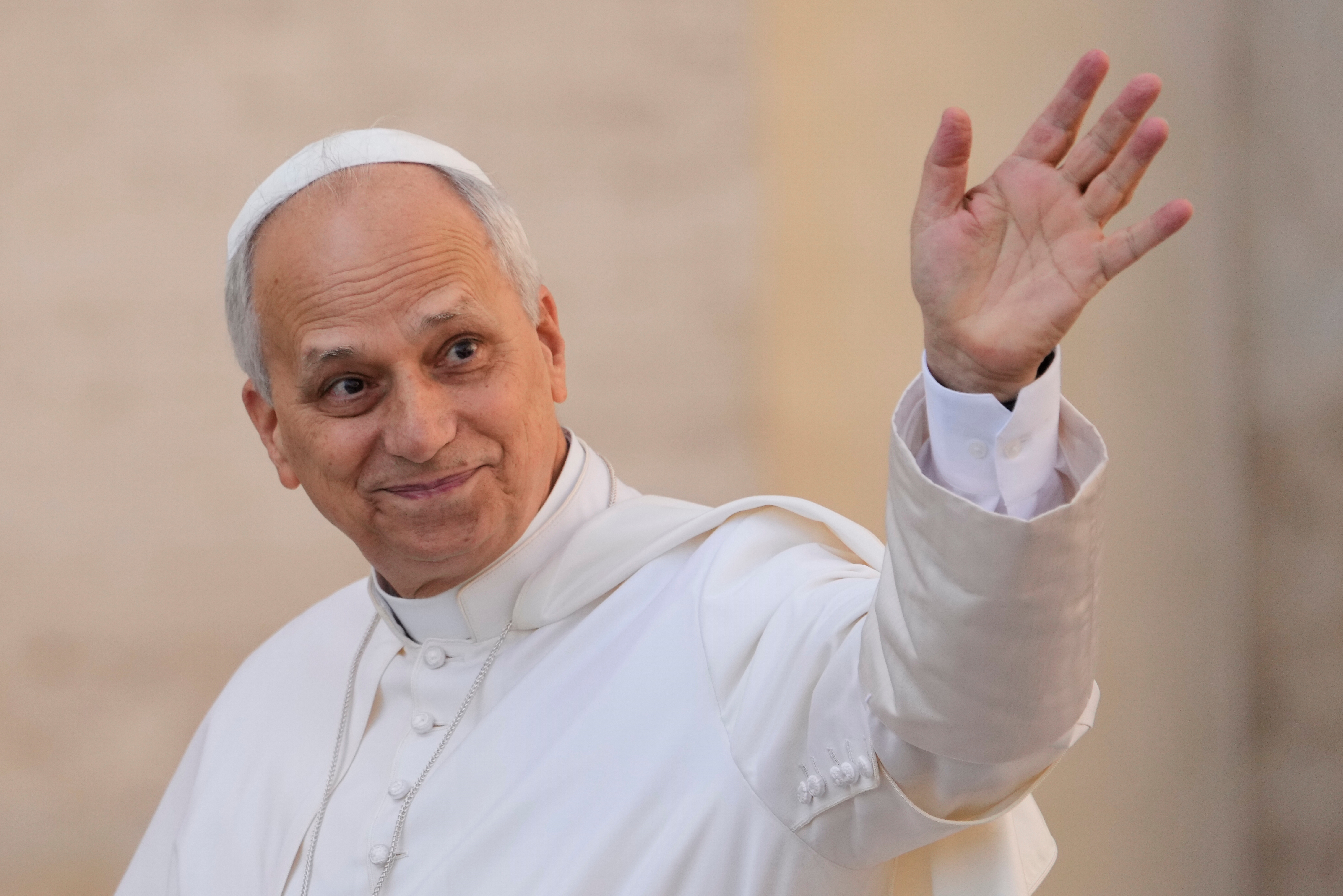 Pope Leo XIV waves as he arrives for his weekly general audience in St. Peter
